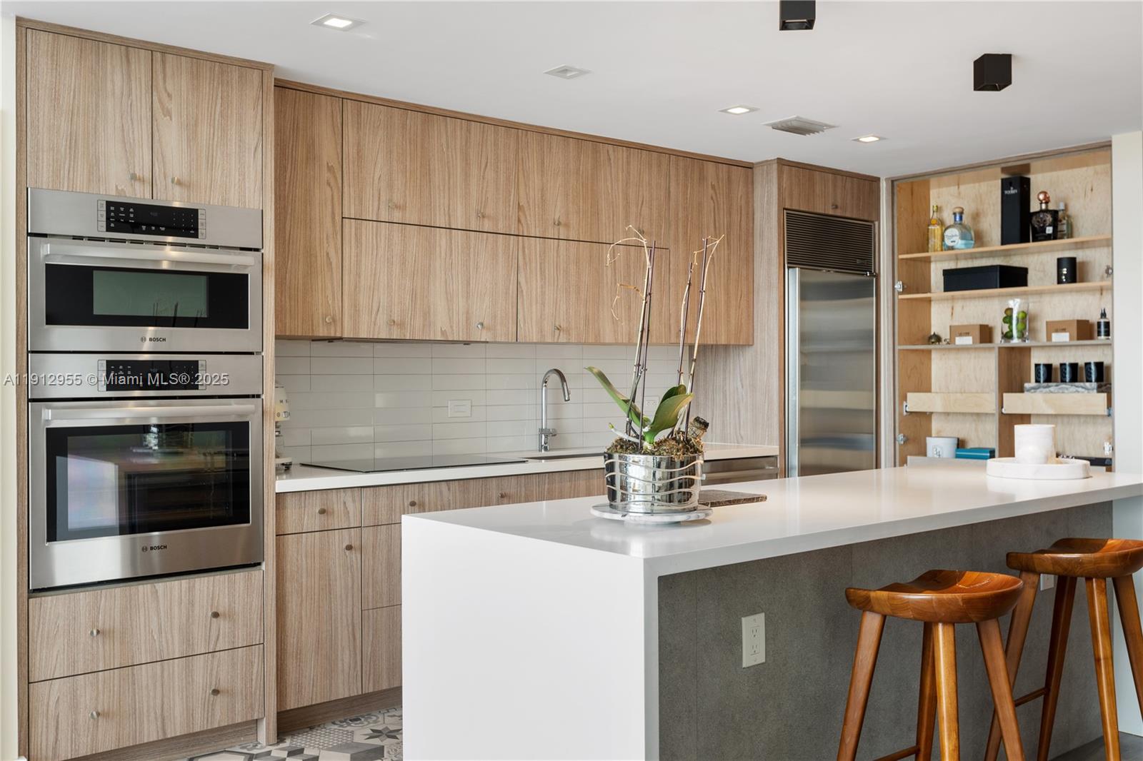 1040 Biscayne Boulevard, Unit 1602 Miami, FL 33132 - Photo 4 of 39 a kitchen with a sink and cabinets