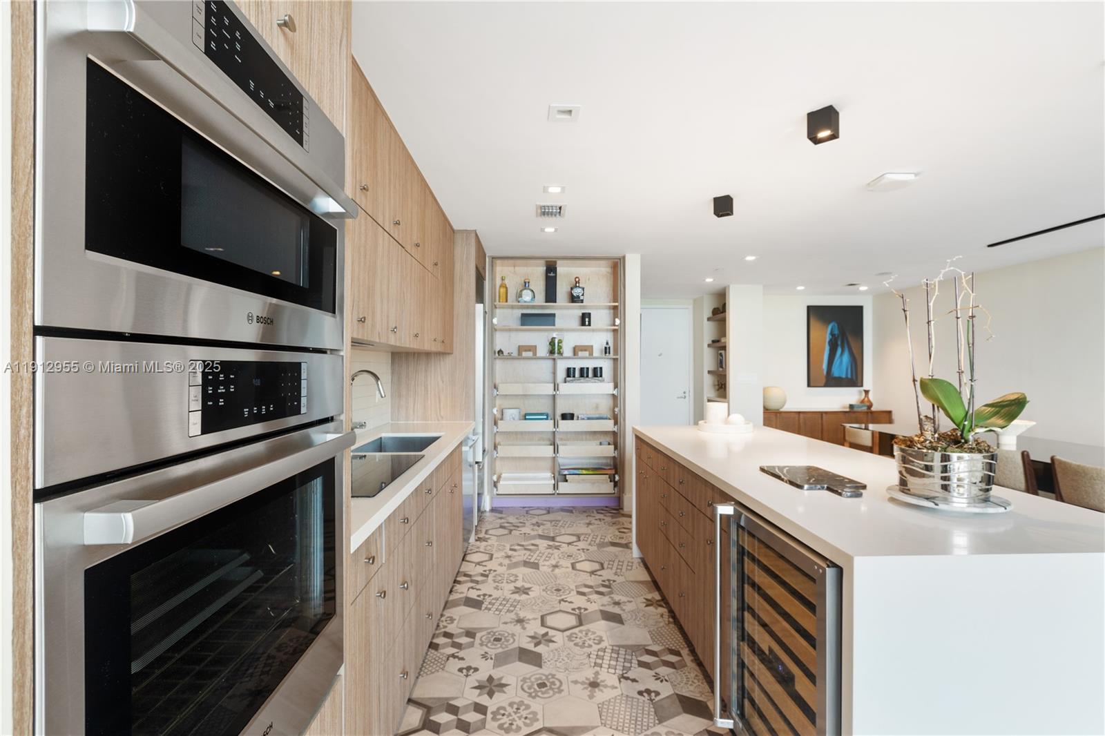 1040 Biscayne Boulevard, Unit 1602 Miami, FL 33132 - Photo 5 of 39 a kitchen with stainless steel appliances a stove microwave and sink