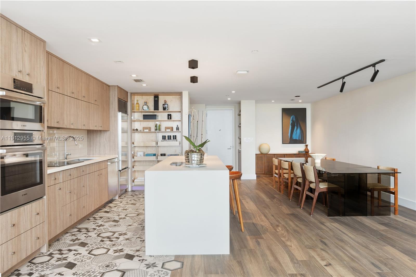 1040 Biscayne Boulevard, Unit 1602 Miami, FL 33132 - Photo 9 of 39 a large white kitchen with lots of counter top space and appliances