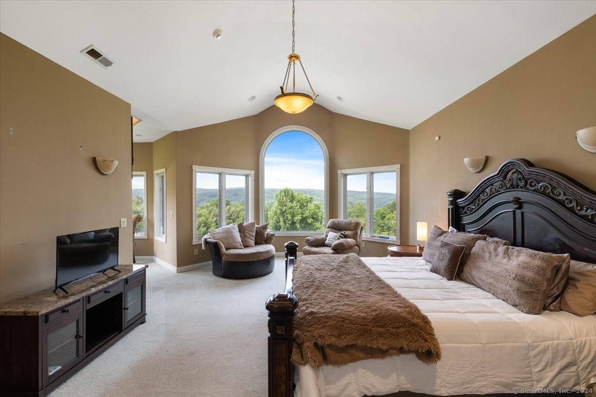 195 Injun Hollow Road Haddam, CT 06424 - Photo 21 of 40 a bedroom with a bed and a couch