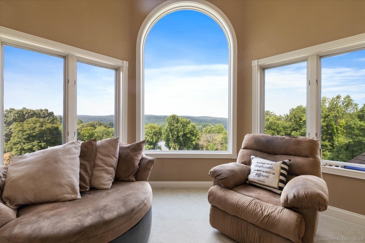 195 Injun Hollow Road Haddam, CT 06424 - Photo 23 of 40 a living room with furniture and a large window