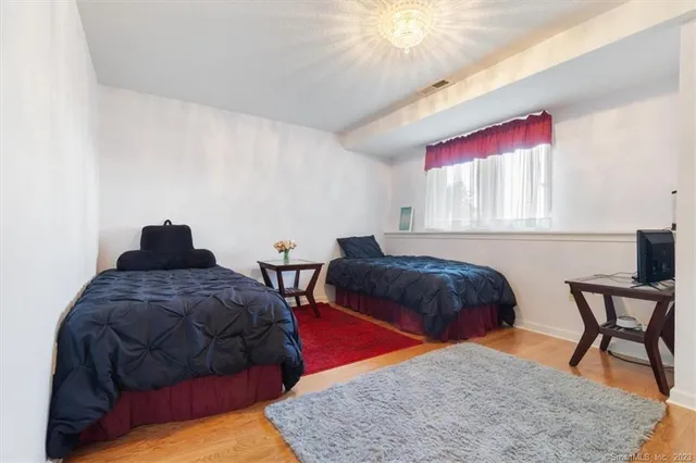 a bedroom with a bed and window