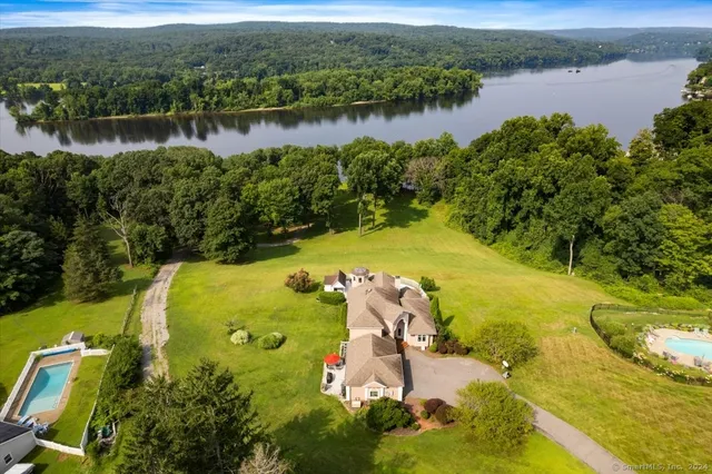 an aerial view of a house with a lake view