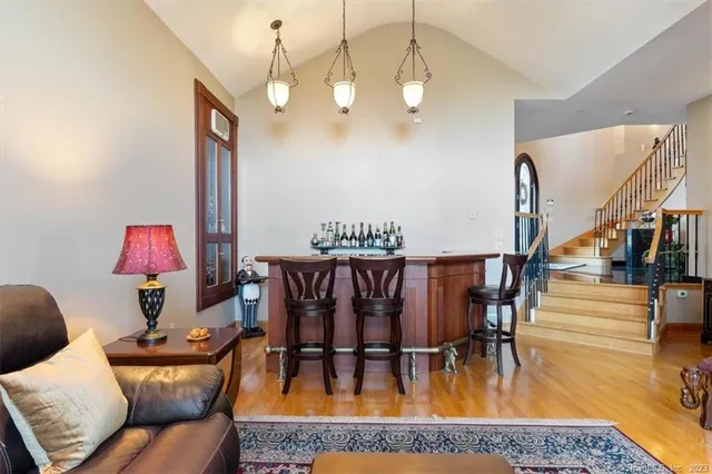 a living room with furniture dining table and a chandelier