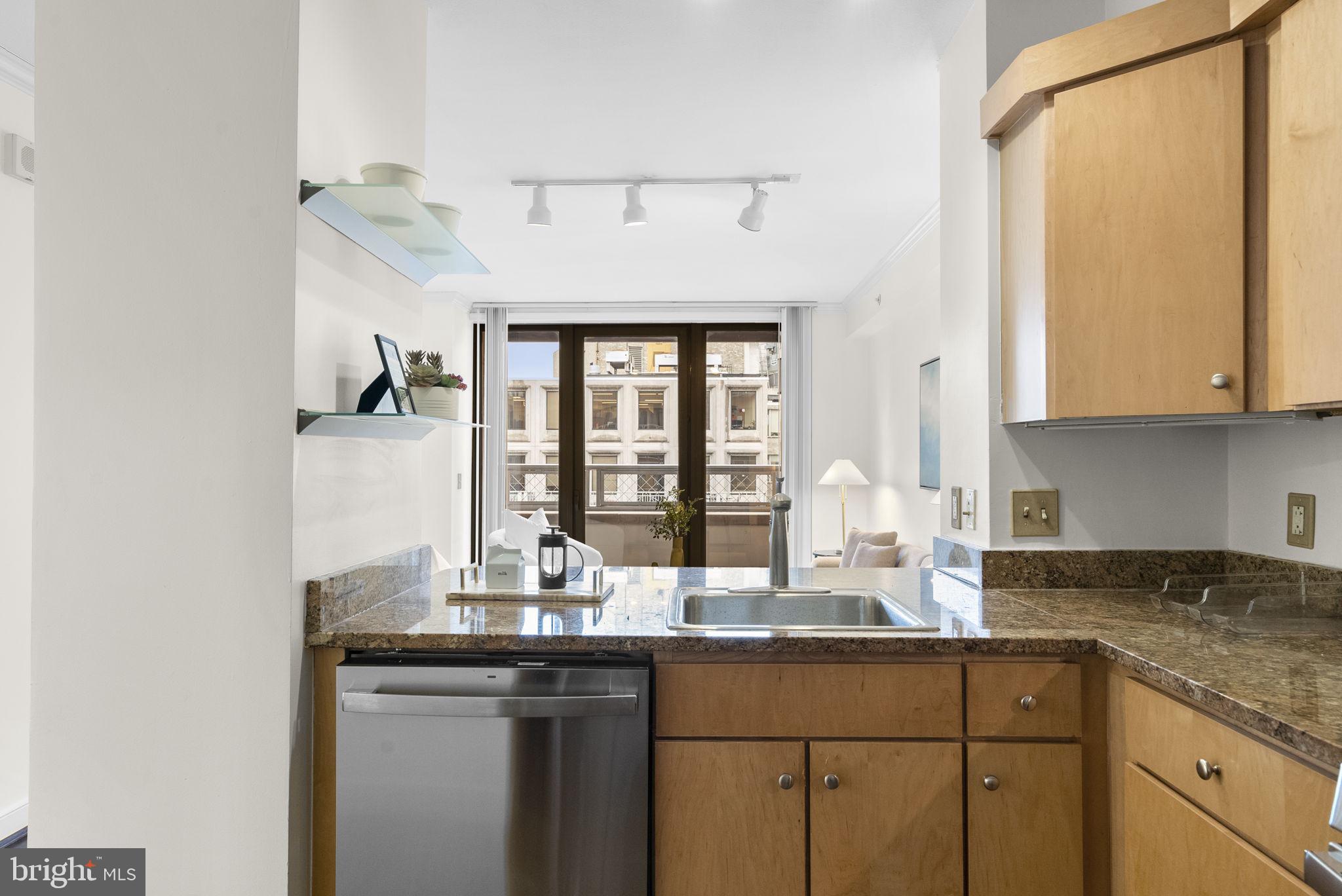 631 D Street Northwest, Unit 1129 Washington, DC 20004 - Photo 12 of 36 a kitchen with granite countertop a sink and cabinets
