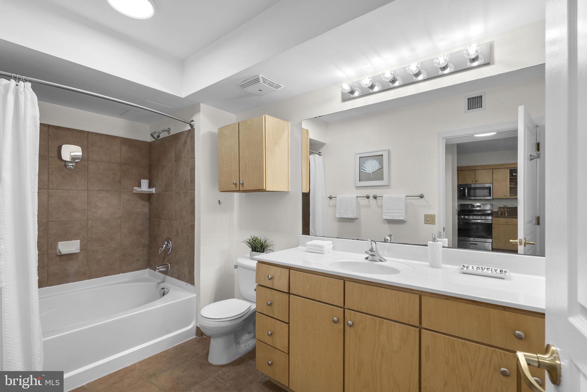 631 D Street Northwest, Unit 1129 Washington, DC 20004 - Photo 15 of 36 a bathroom with a sink a toilet and shower