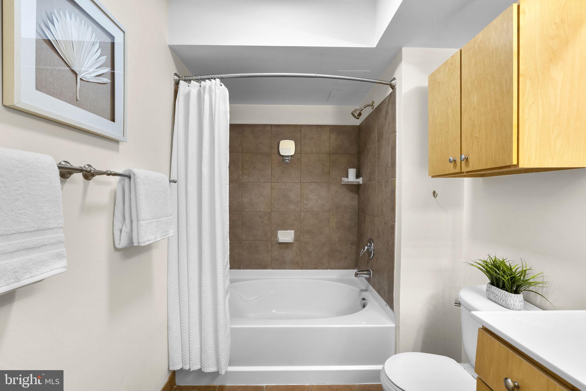 631 D Street Northwest, Unit 1129 Washington, DC 20004 - Photo 16 of 36 a bathroom with a shower and a toilet