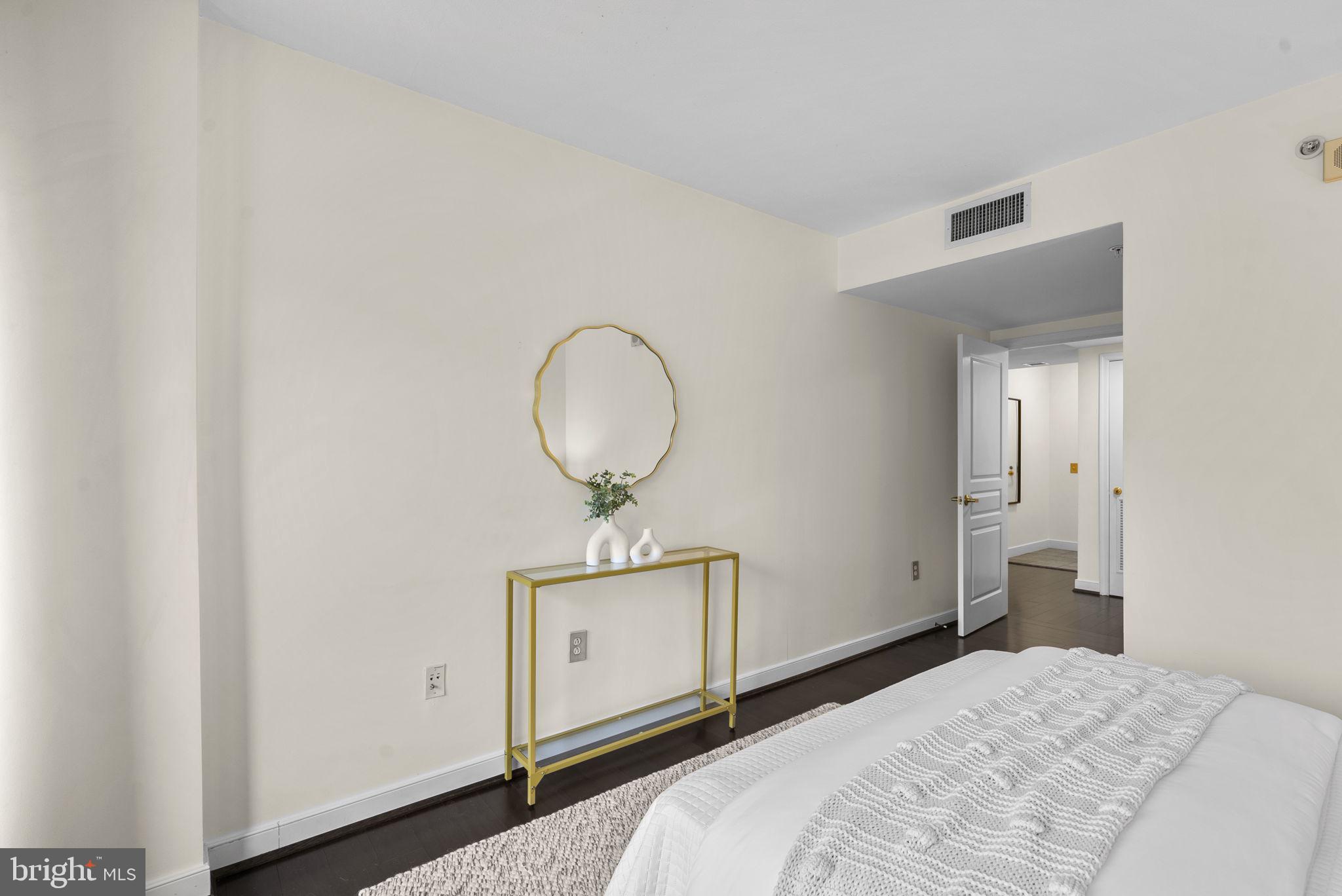 631 D Street Northwest, Unit 1129 Washington, DC 20004 - Photo 19 of 36 a bedroom with a bed and wooden floor