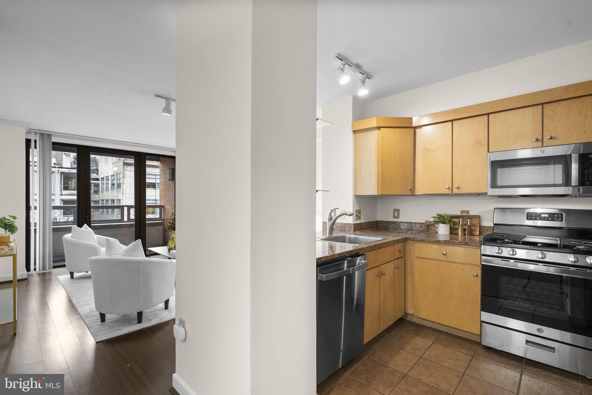 631 D Street Northwest, Unit 1129 Washington, DC 20004 - Photo 9 of 36 a kitchen with a sink stove top oven and cabinets