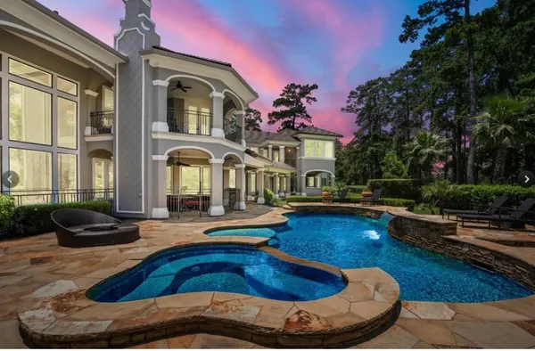 a view of a house with swimming pool and sitting area
