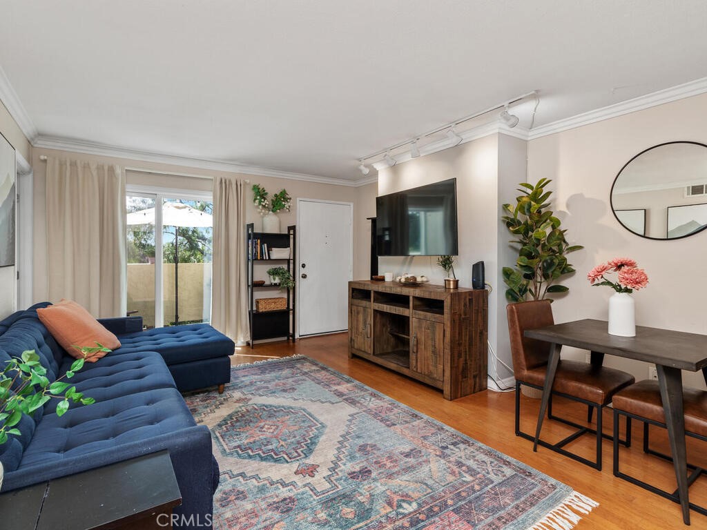 6907 Quail Place, Unit F Carlsbad, CA 92009 - Photo 1 of 23 a living room with furniture and a flat screen tv