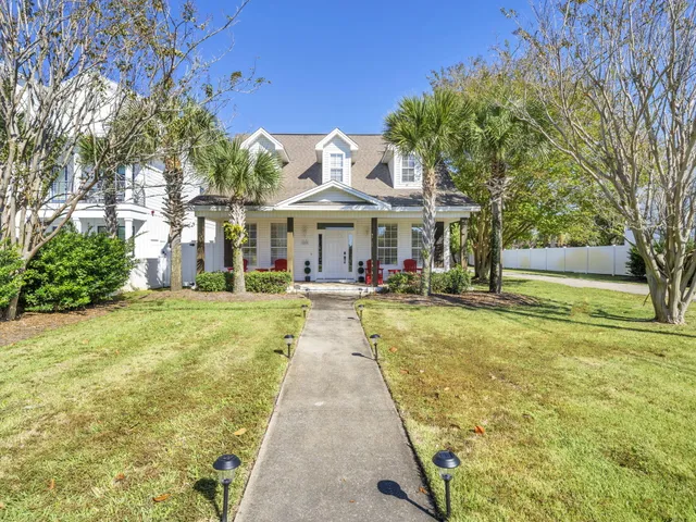 a front view of a house with swimming pool and porch