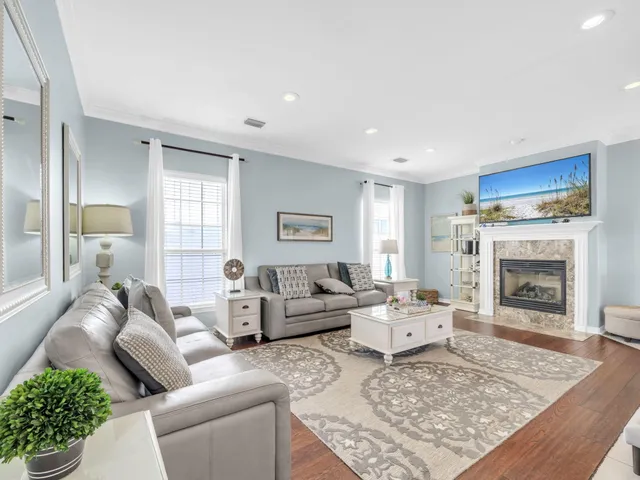 a living room with furniture and a ceiling fan