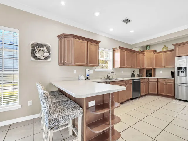 an aerial view of residential houses with outdoor space and parking