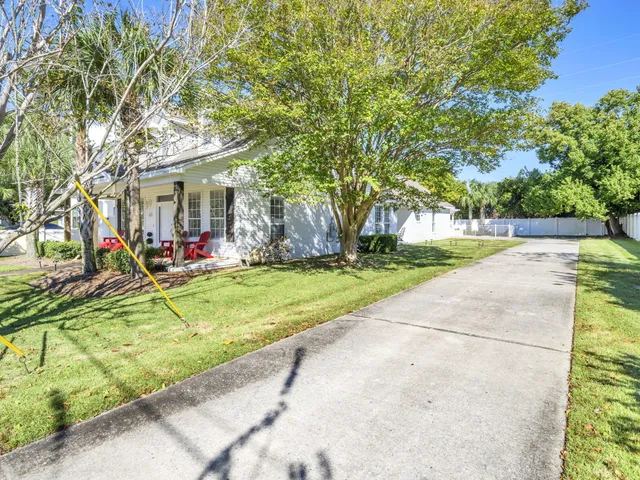 a view of a house with swimming pool and a yard