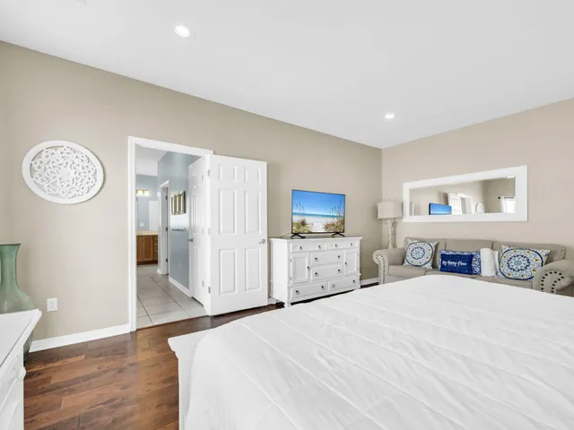 a front view of a house with a tree