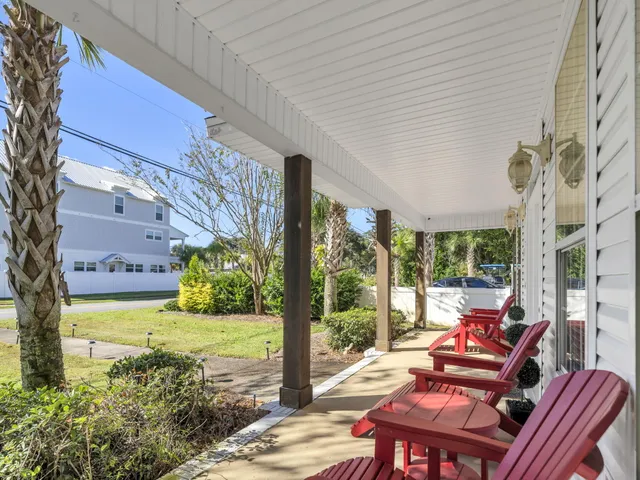 a view of a patio with couches table and chairs and potted plants