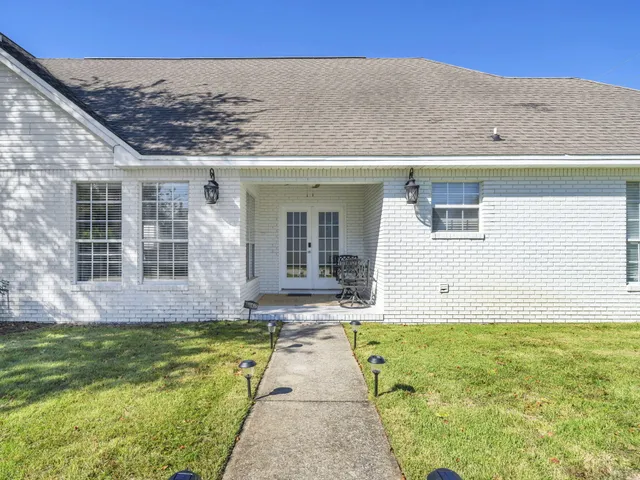 a view of a patio with table and chairs and potted plants