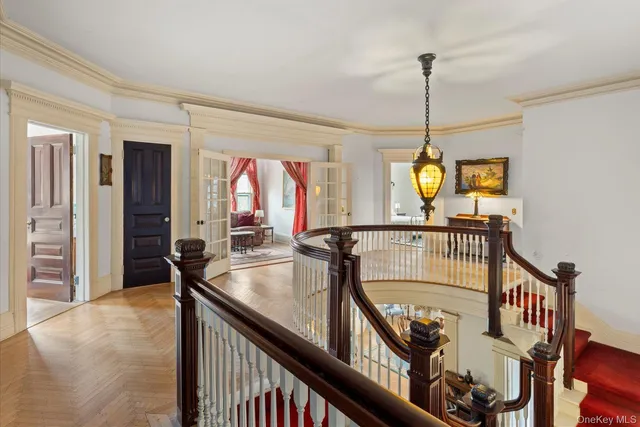 a view of a hallway to a livingroom and a chandelier