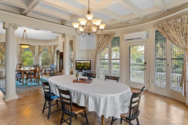 a living room with furniture a fireplace and a chandelier