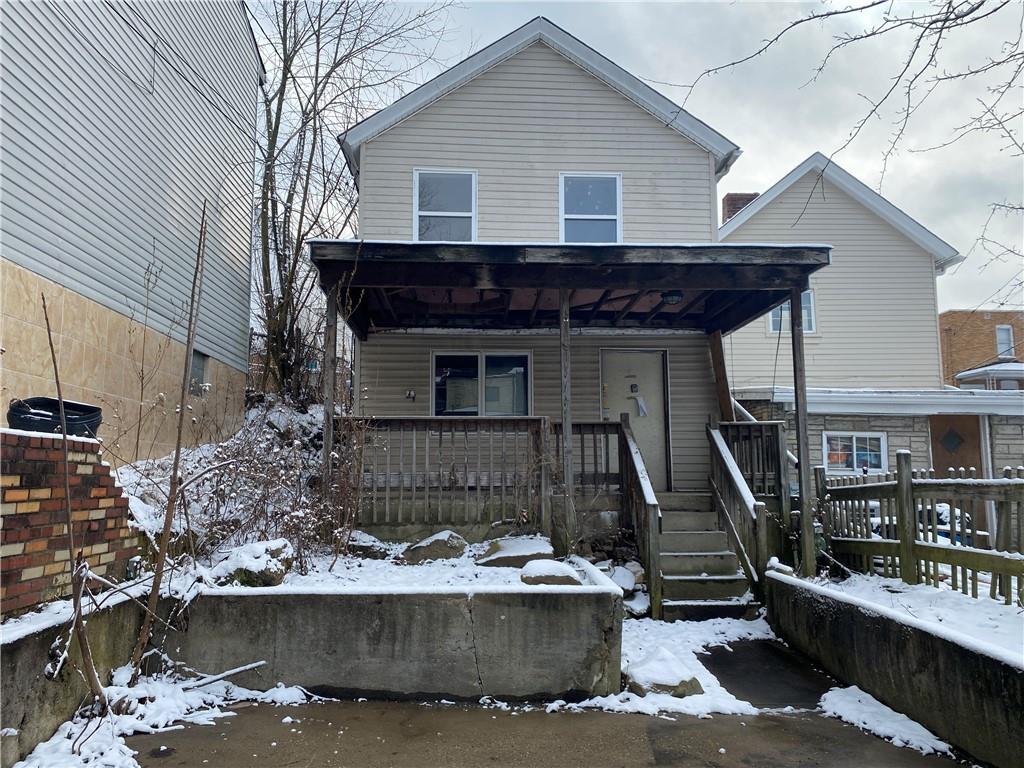 97 Frazier Avenue McKees Rocks, PA 15136 - Photo 1 of 13 a front view of a house with garage
