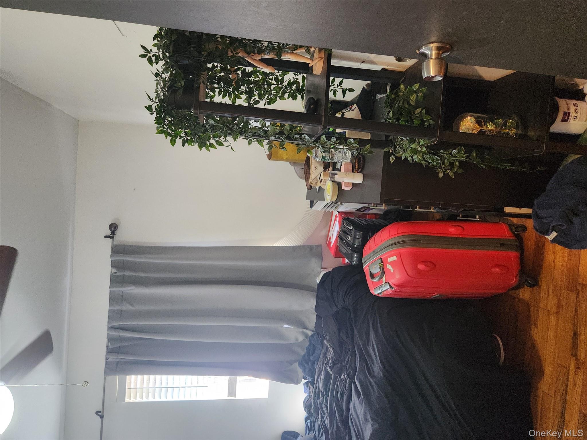 142-34 Bascom Avenue Queens, NY 11436 - Photo 11 of 21 Bedroom featuring wood finished floors and a ceiling fan