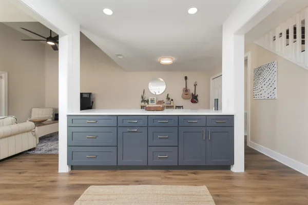 a spacious bathroom with a granite countertop sink and a mirror