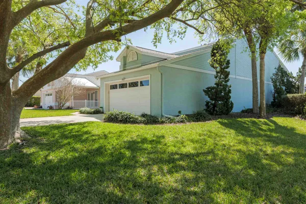 a view of a house with yard and tree s