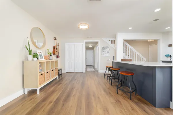 a living room with furniture and a wooden floor