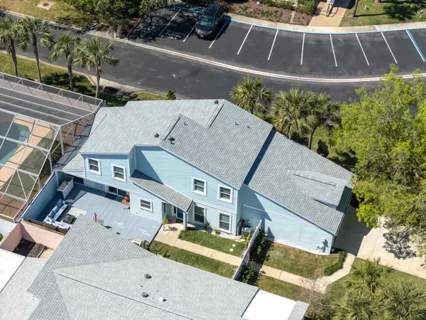 an aerial view of a house with a yard