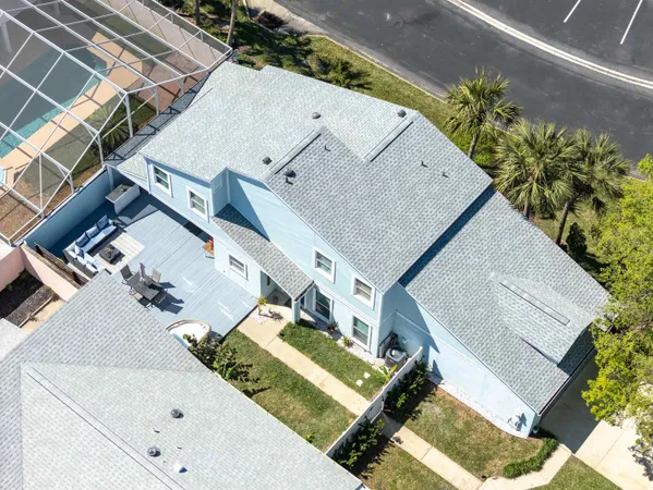 an aerial view of a house with a yard