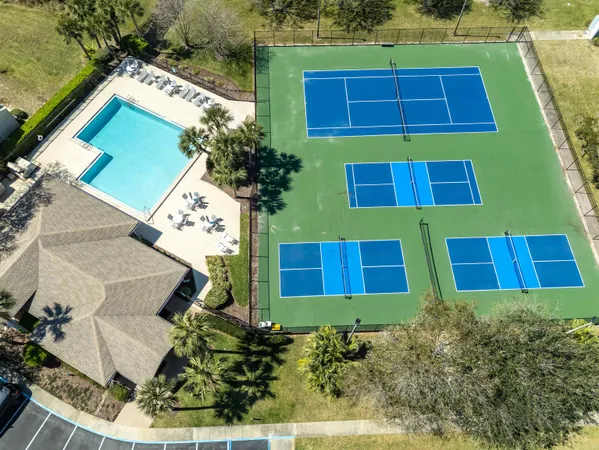 an aerial view of a house with a yard and potted plants