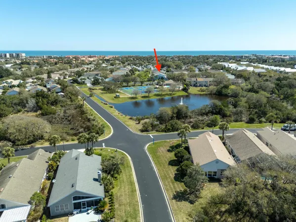 an aerial view of a house with a lake view