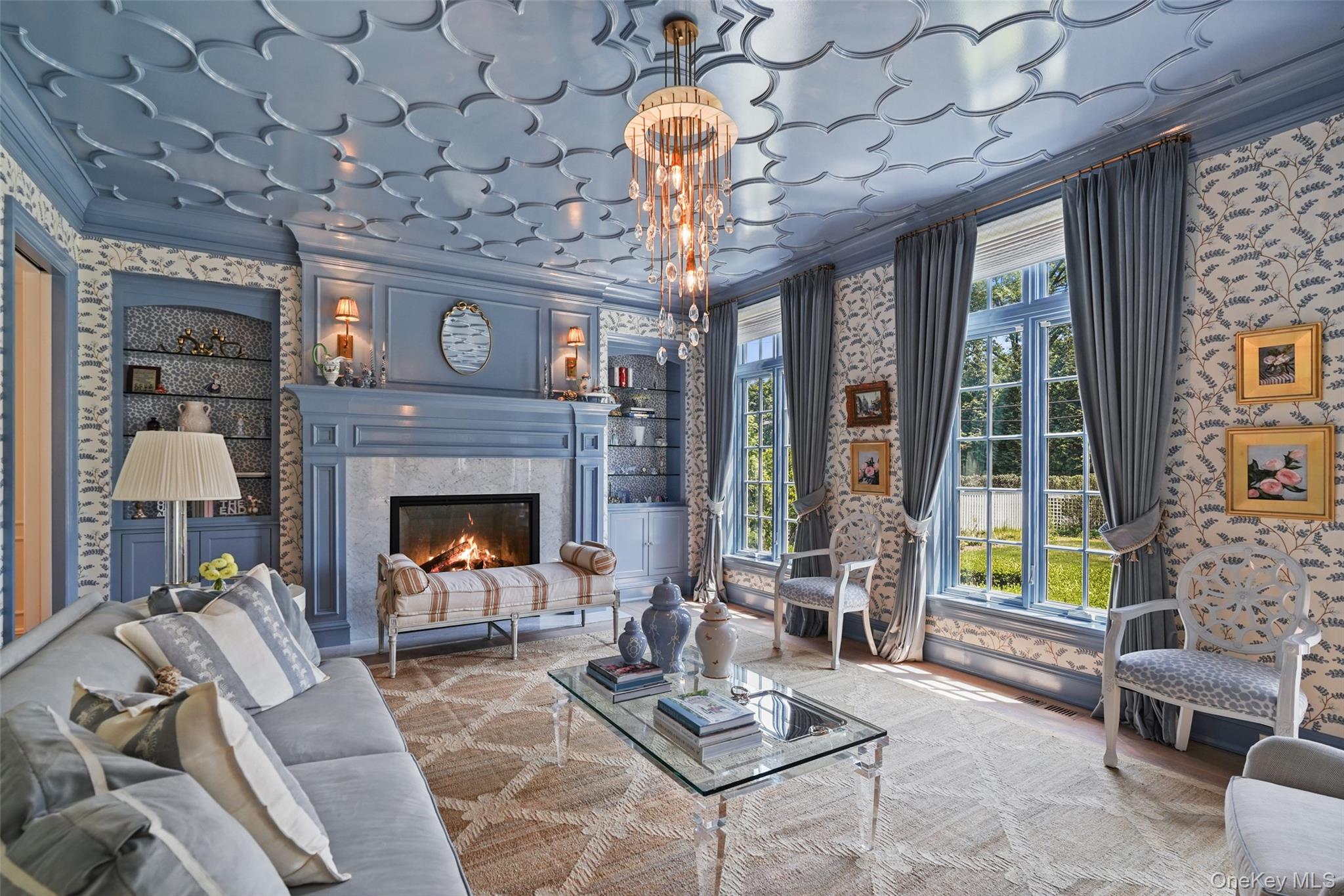 27 Murray Hill Road Scarsdale, NY 10583 - Photo 10 of 29 a living room with furniture a fireplace and a chandelier