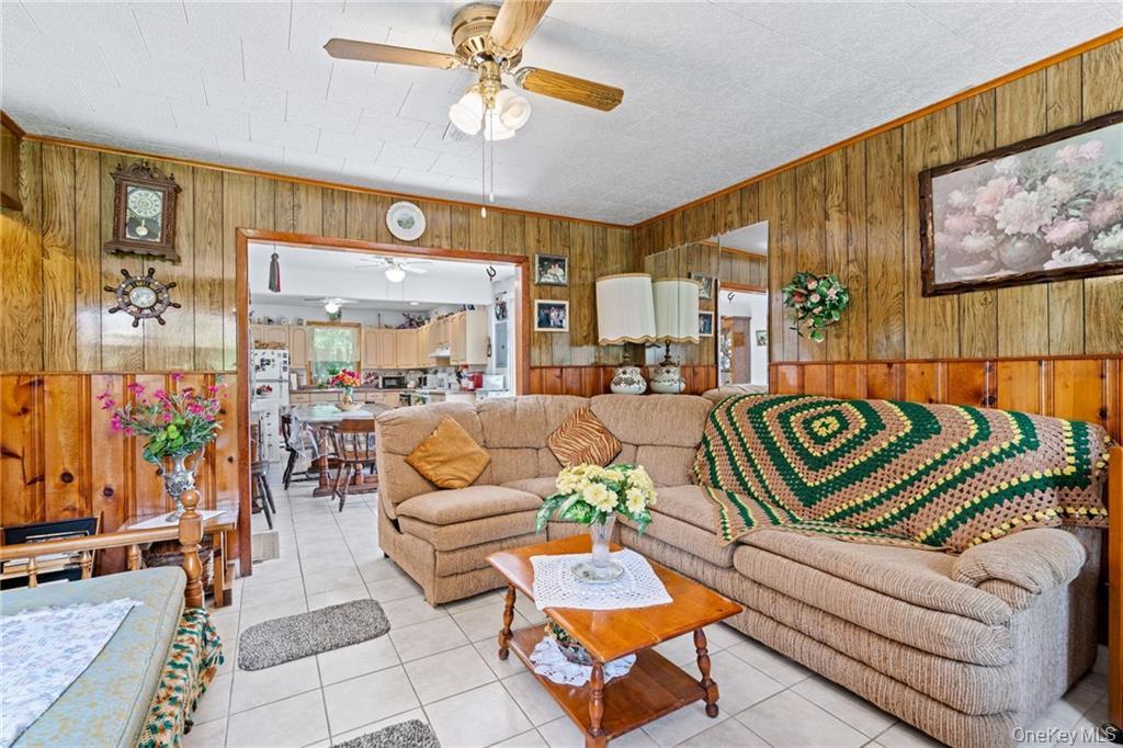 6 Leonard Road Monticello, NY 12701 - Photo 11 of 35 a living room with patio furniture and a chandelier