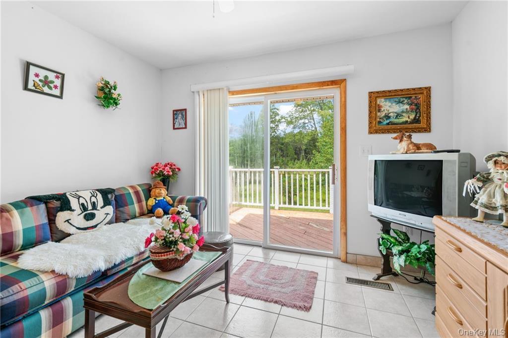6 Leonard Road Monticello, NY 12701 - Photo 15 of 35 a living room with furniture and a flat screen tv