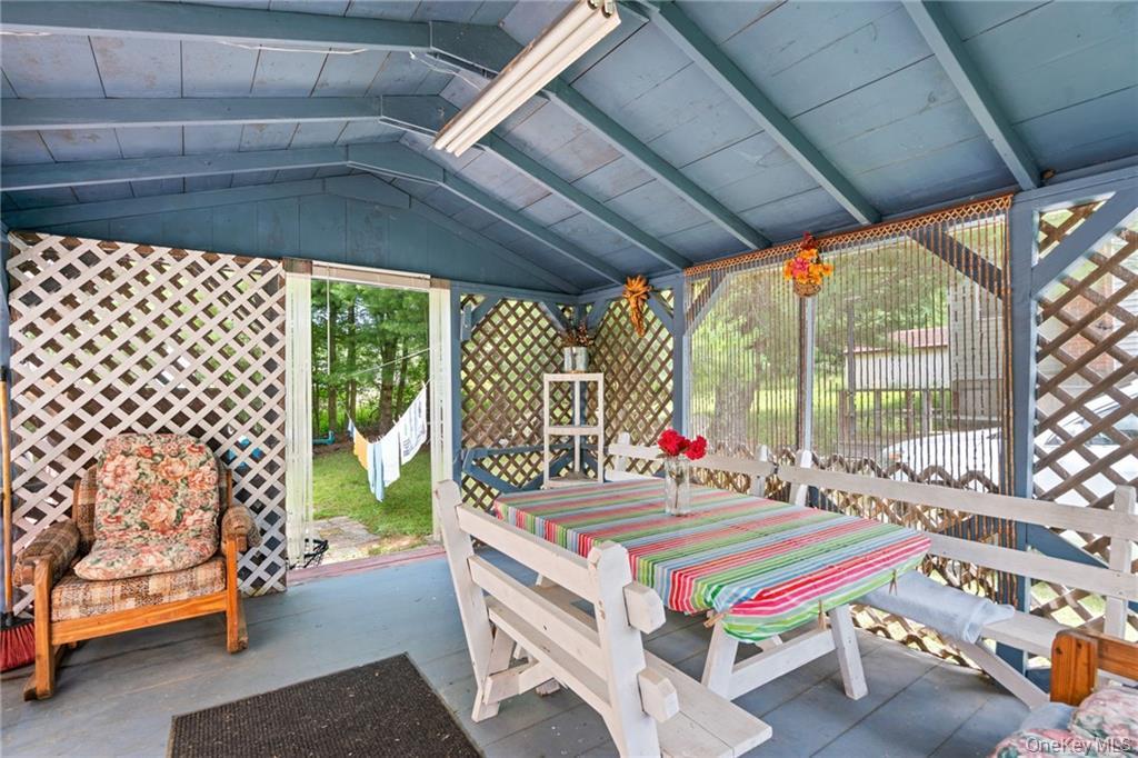 6 Leonard Road Monticello, NY 12701 - Photo 29 of 35 a living room with a baby crib furniture and a chandelier