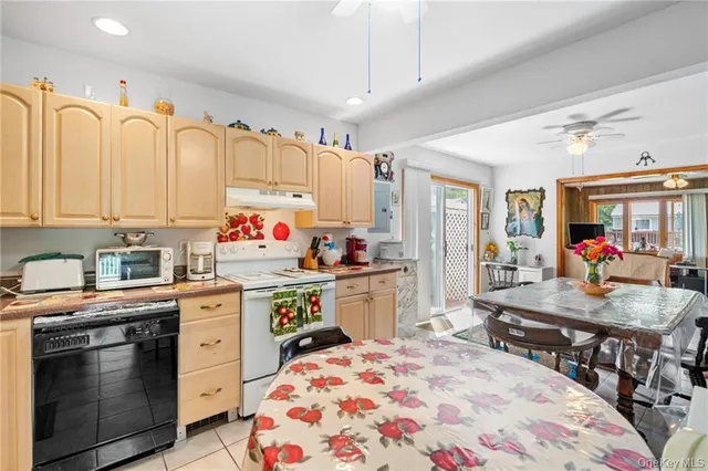 a open kitchen with stainless steel appliances granite countertop a sink dishwasher and a stove with wooden floor