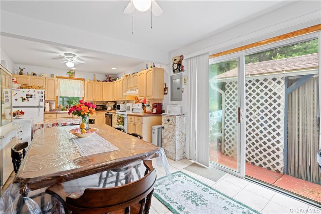 6 Leonard Road Monticello, NY 12701 - Photo 9 of 35 a room with stainless steel appliances kitchen island granite countertop a table chairs and a view of kitchen
