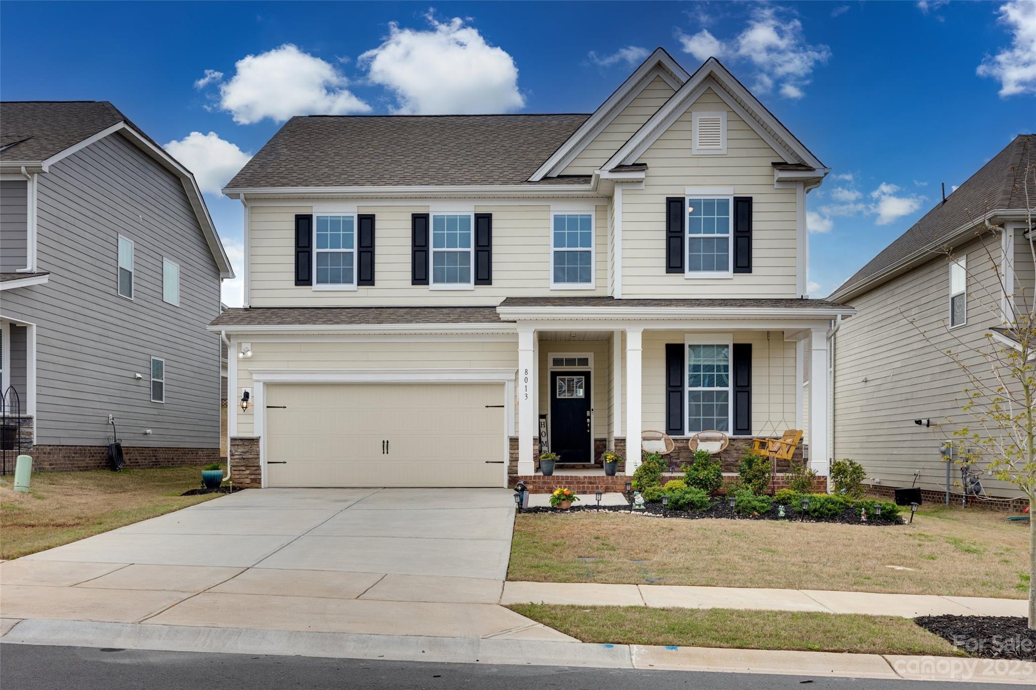 8013 Oakmere Road Waxhaw, NC 28173 - Photo 1 of 30 a view of a white house with a yard and potted plants