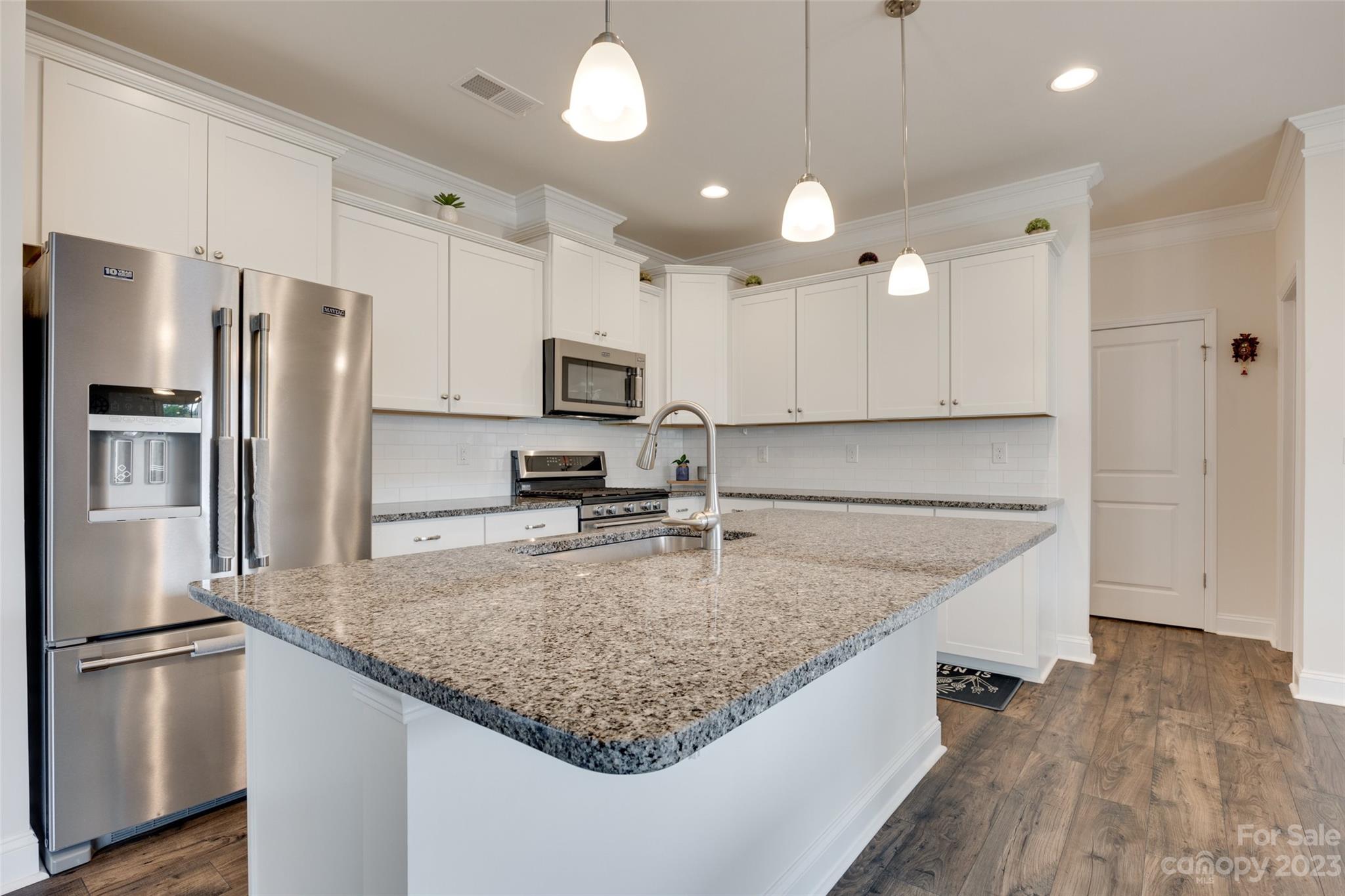 8013 Oakmere Road Waxhaw, NC 28173 - Photo 12 of 30 a kitchen with stainless steel appliances granite countertop a refrigerator a sink a stove a microwave and island