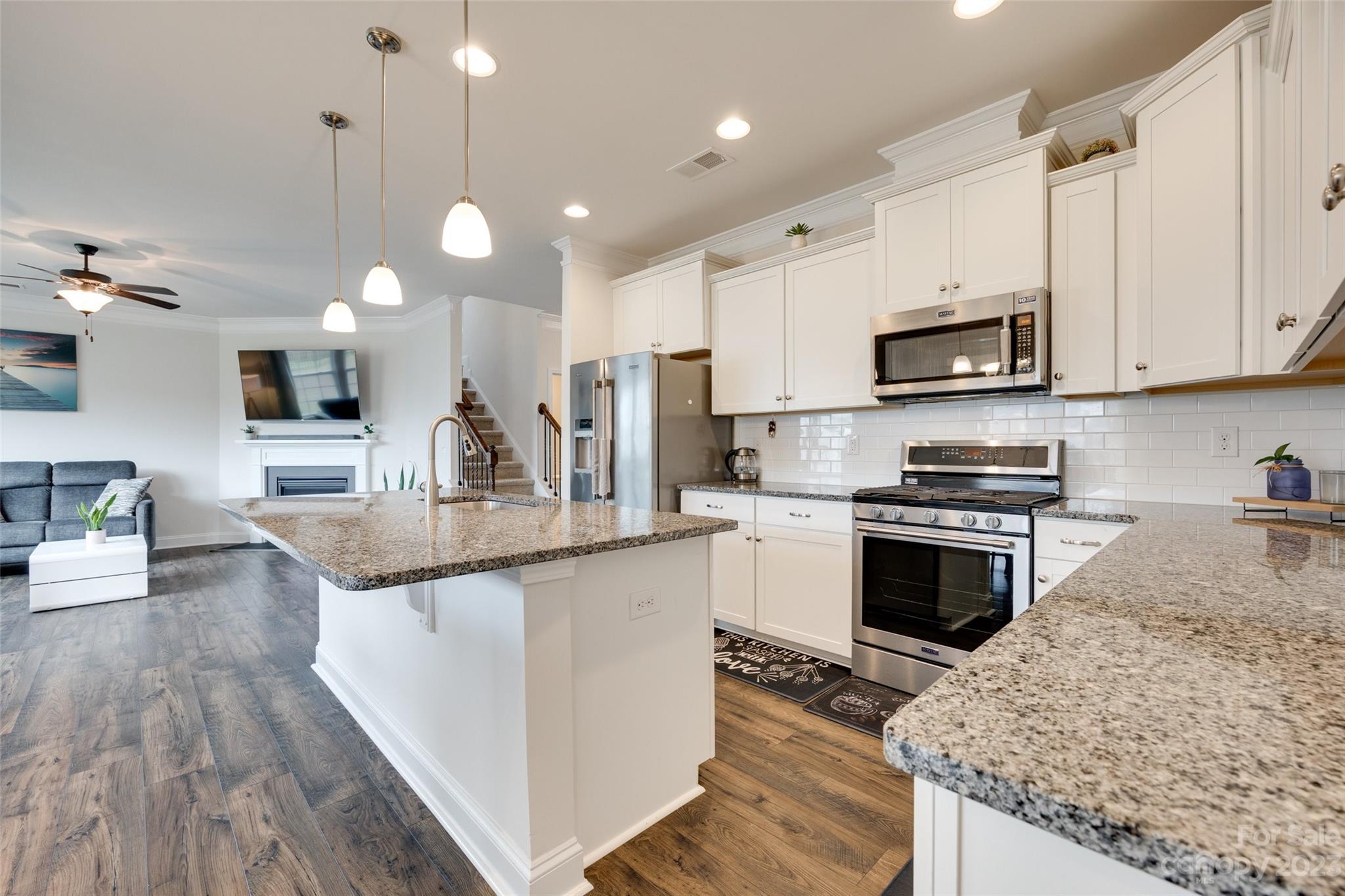 8013 Oakmere Road Waxhaw, NC 28173 - Photo 15 of 30 a kitchen with stainless steel appliances granite countertop a sink a stove top oven a counter space and cabinets