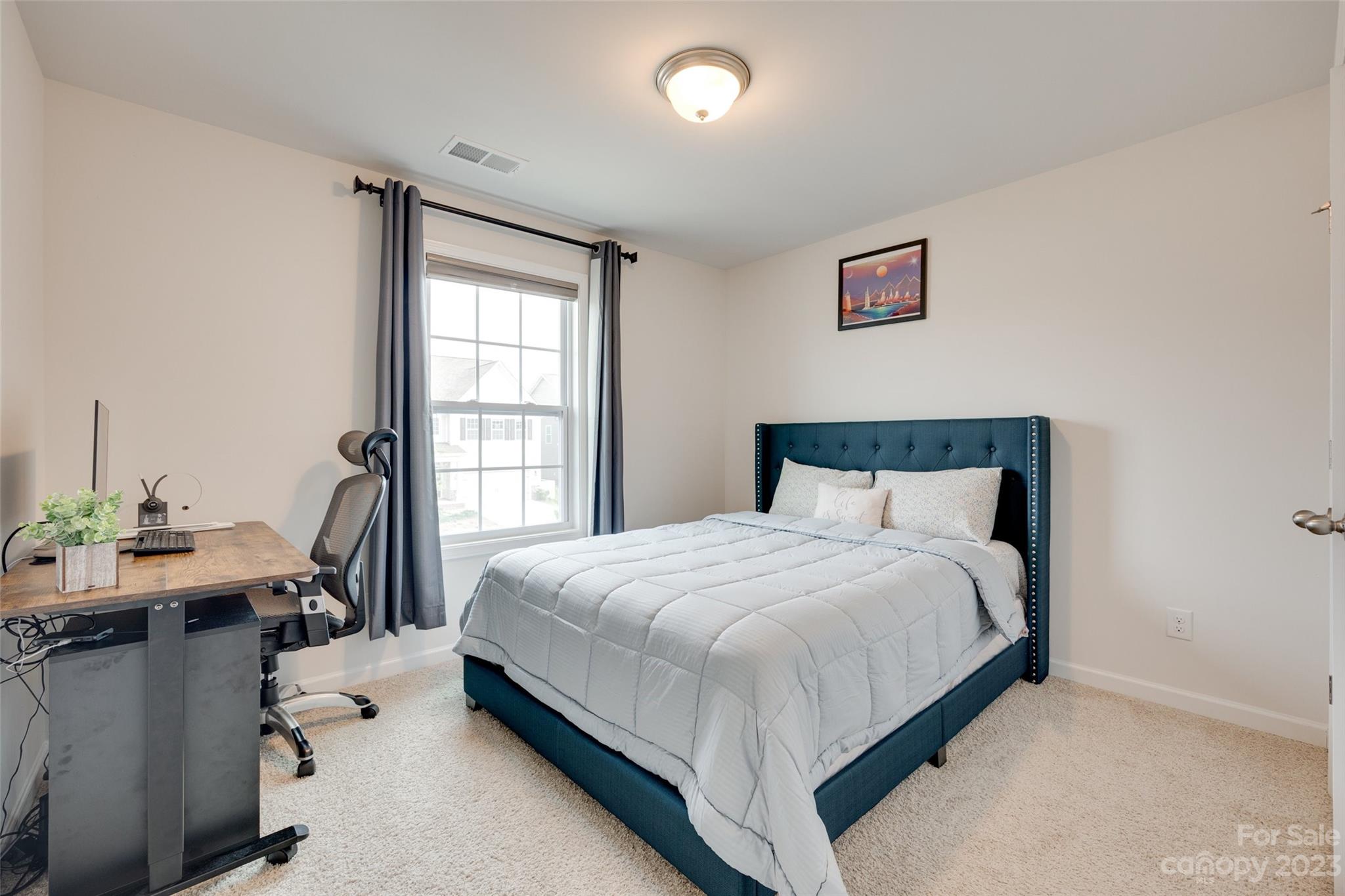 8013 Oakmere Road Waxhaw, NC 28173 - Photo 18 of 30 a bedroom with a bed and a table