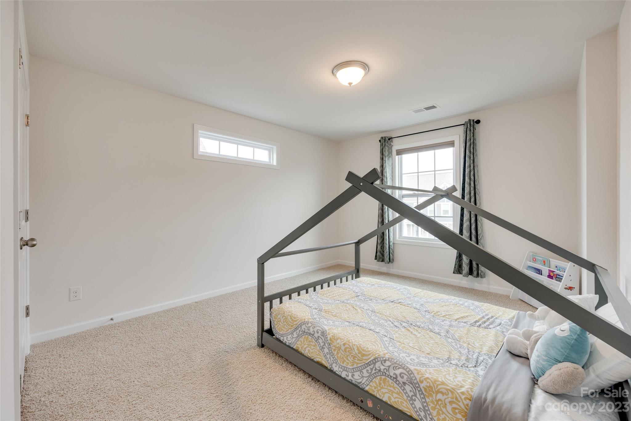 8013 Oakmere Road Waxhaw, NC 28173 - Photo 19 of 30 a white bed sitting in a room next to a window