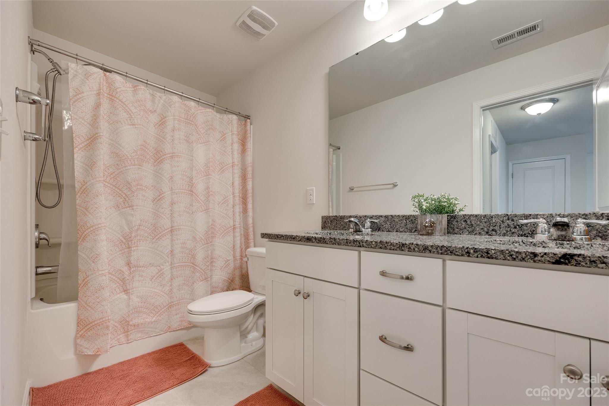 8013 Oakmere Road Waxhaw, NC 28173 - Photo 21 of 30 a bathroom with a granite countertop sink and a mirror