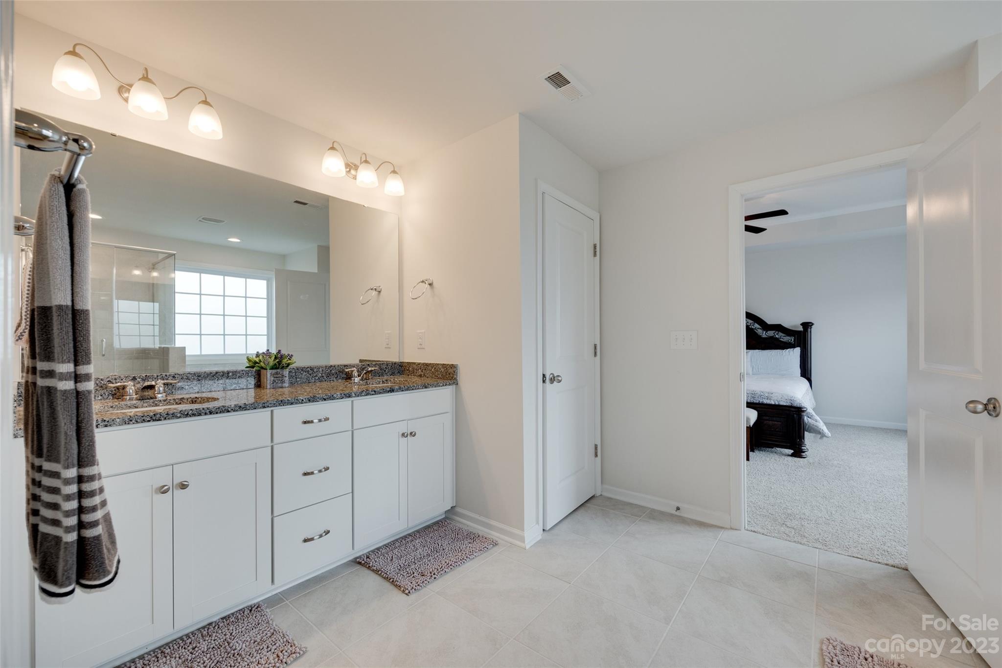 8013 Oakmere Road Waxhaw, NC 28173 - Photo 26 of 30 a bathroom with a granite countertop sink mirror and