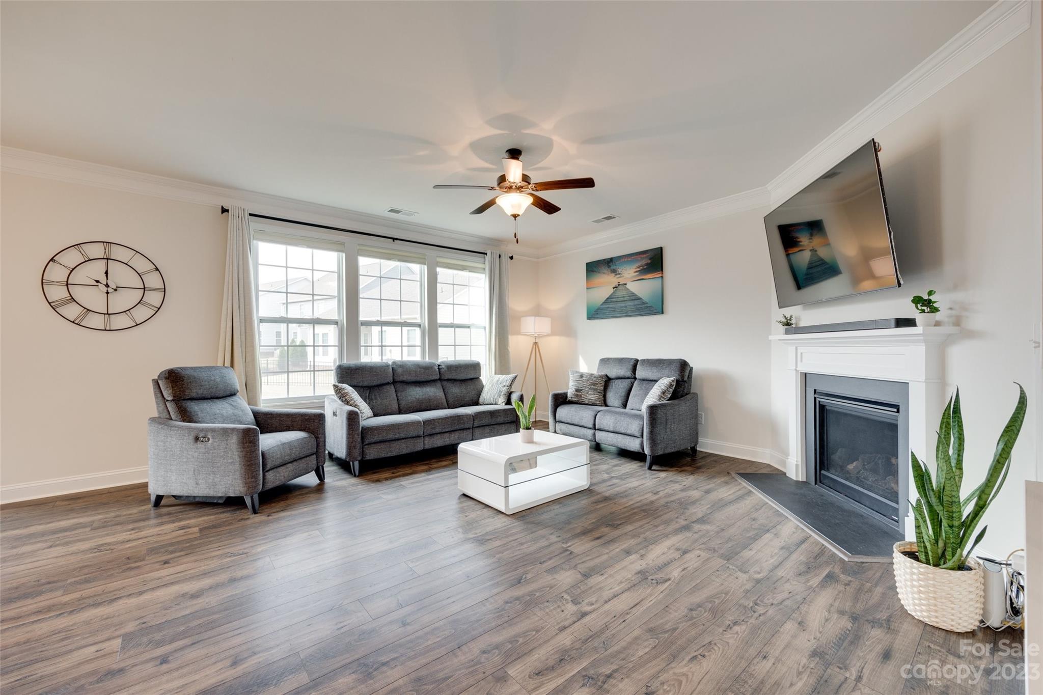 8013 Oakmere Road Waxhaw, NC 28173 - Photo 8 of 30 a living room with furniture a fireplace and a flat screen tv