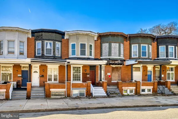 a front view of a residential apartment building with a yard