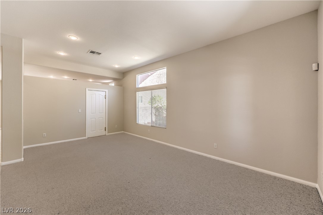 3713 Spring Shadow Road Las Vegas, NV 89129 - Photo 9 of 37 A spacious room offers ample natural light and a neutral palette, perfect for personalized styling.