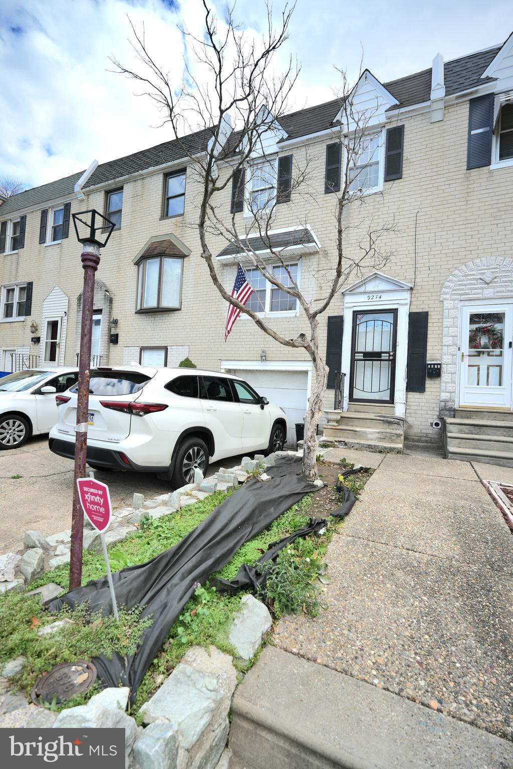 a front view of a building with cars parked